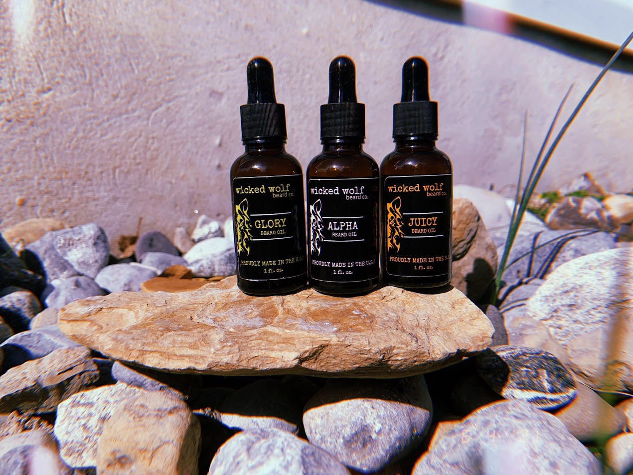 “Alpha Beard Oil lifestyle photo – Wicked Wolf beard oil shown with grooming tools”